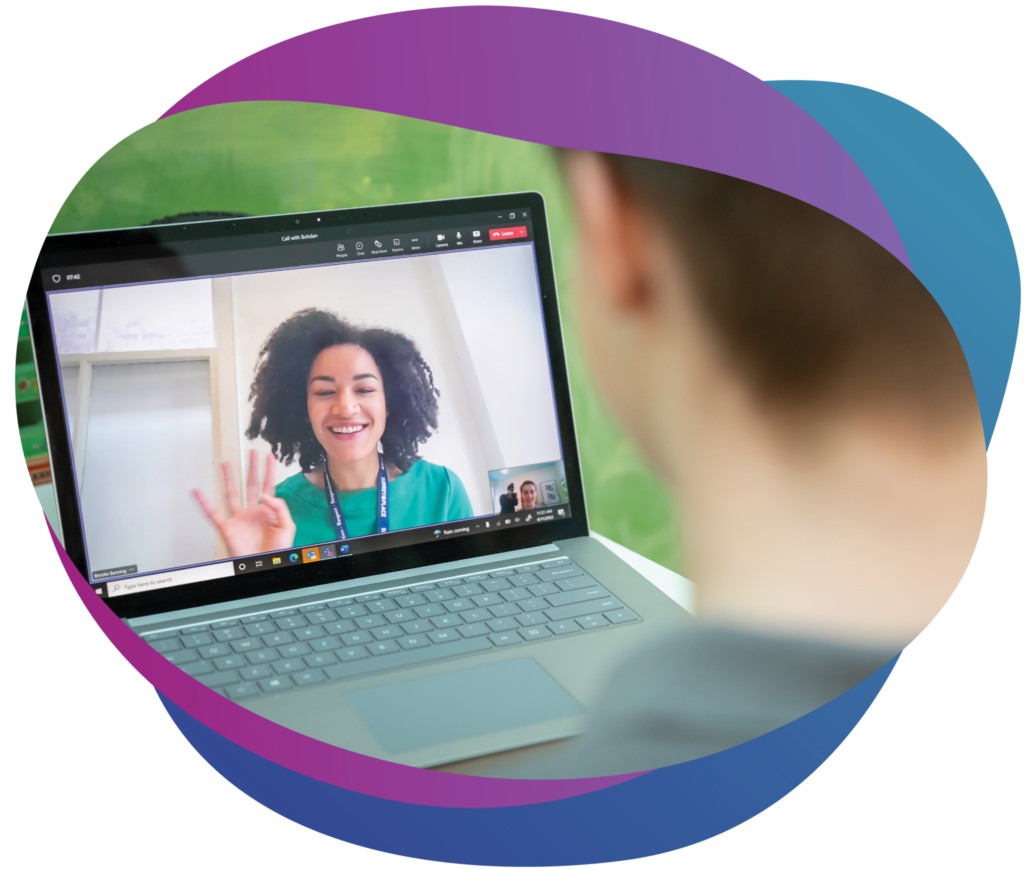 Smiling therapist on video call with child, illustrating virtual therapy session for autism services.